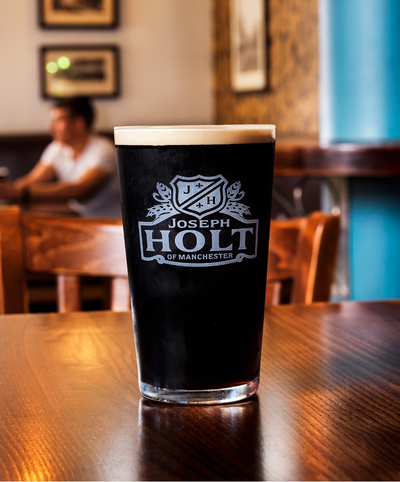 joseph holt black ale pint glass on table