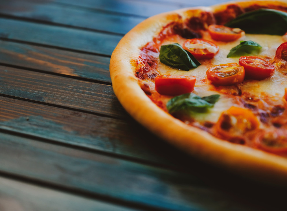 stone baked pizza on wooden table