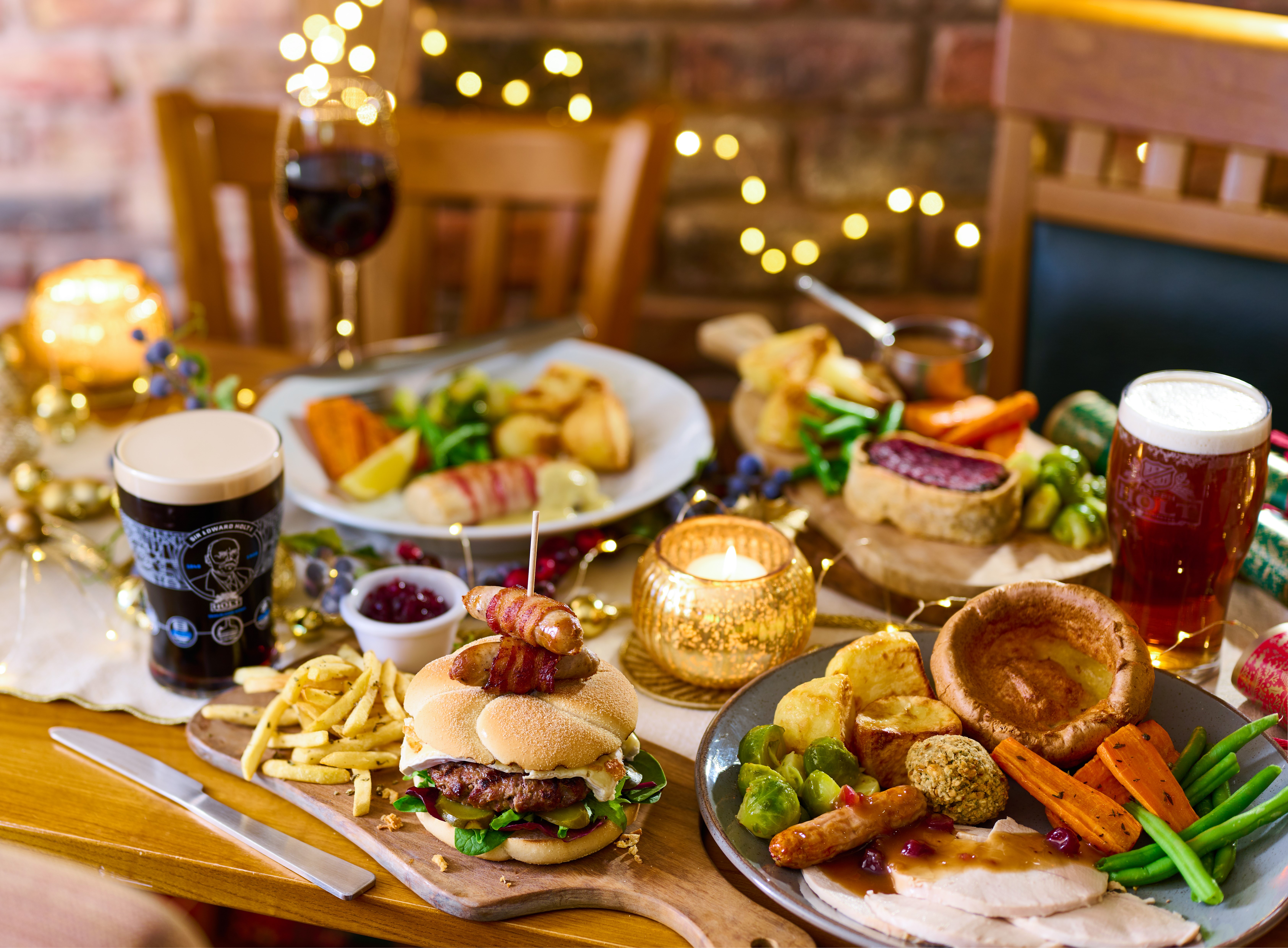 A dinner table filled with Joseph Holt festive food accompanied by beers and wine