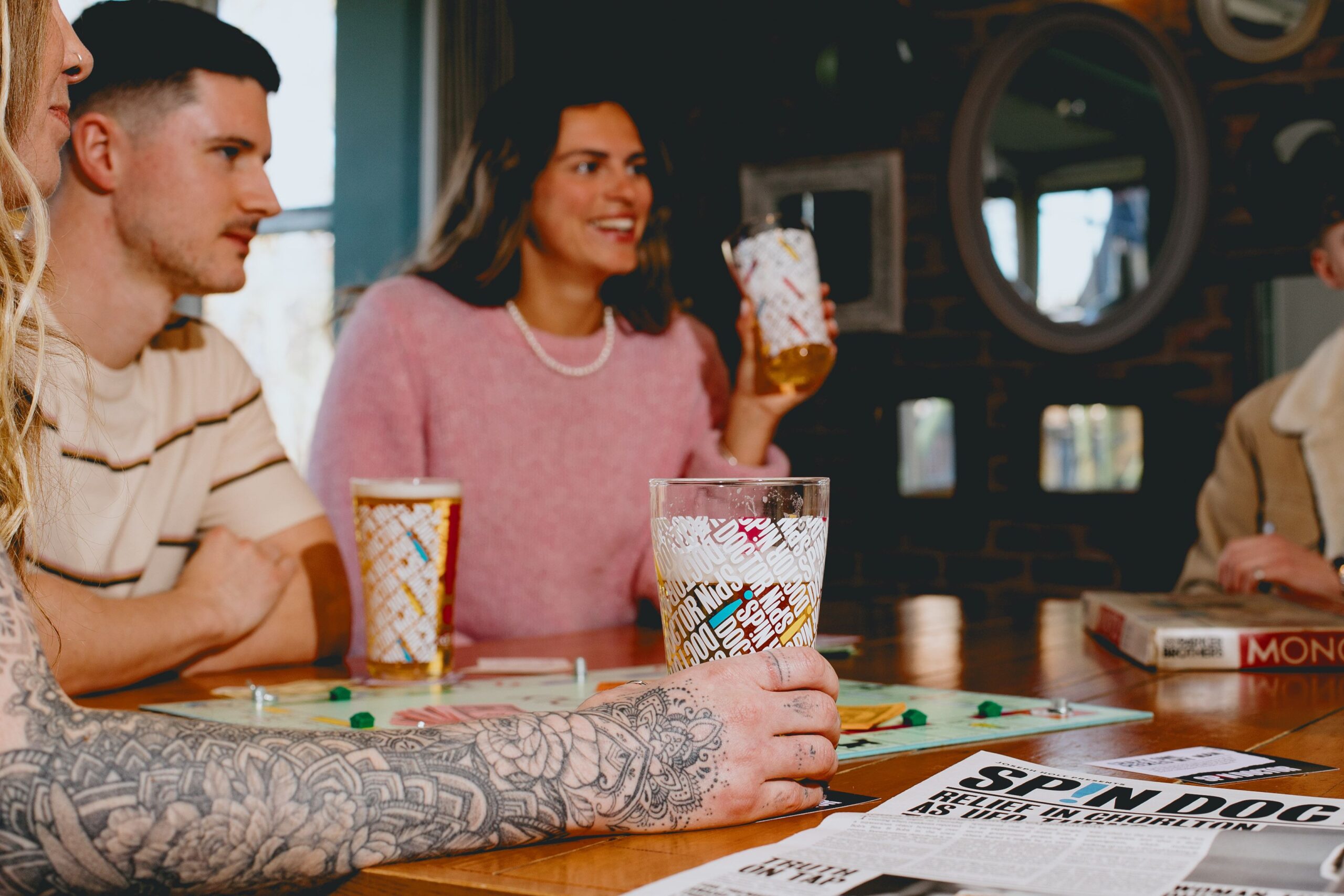 A group playing Monopoly whilst drinking beer